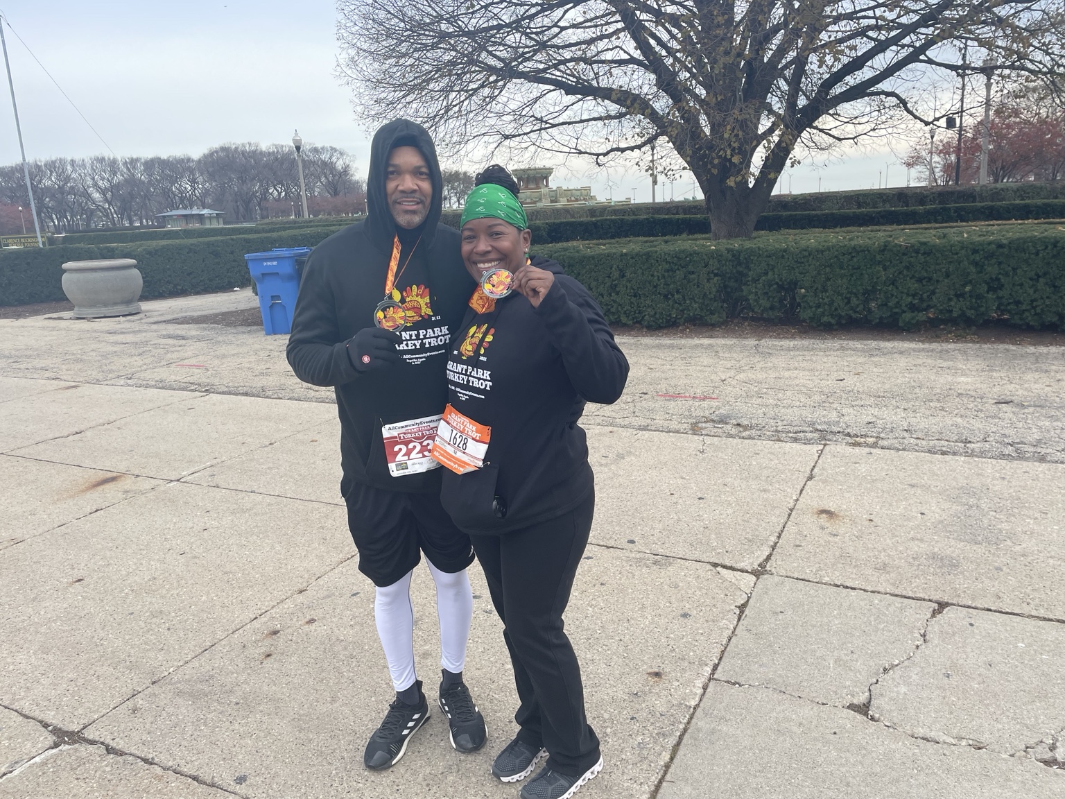 Two race participants displaying their medals after a Turkey Trot