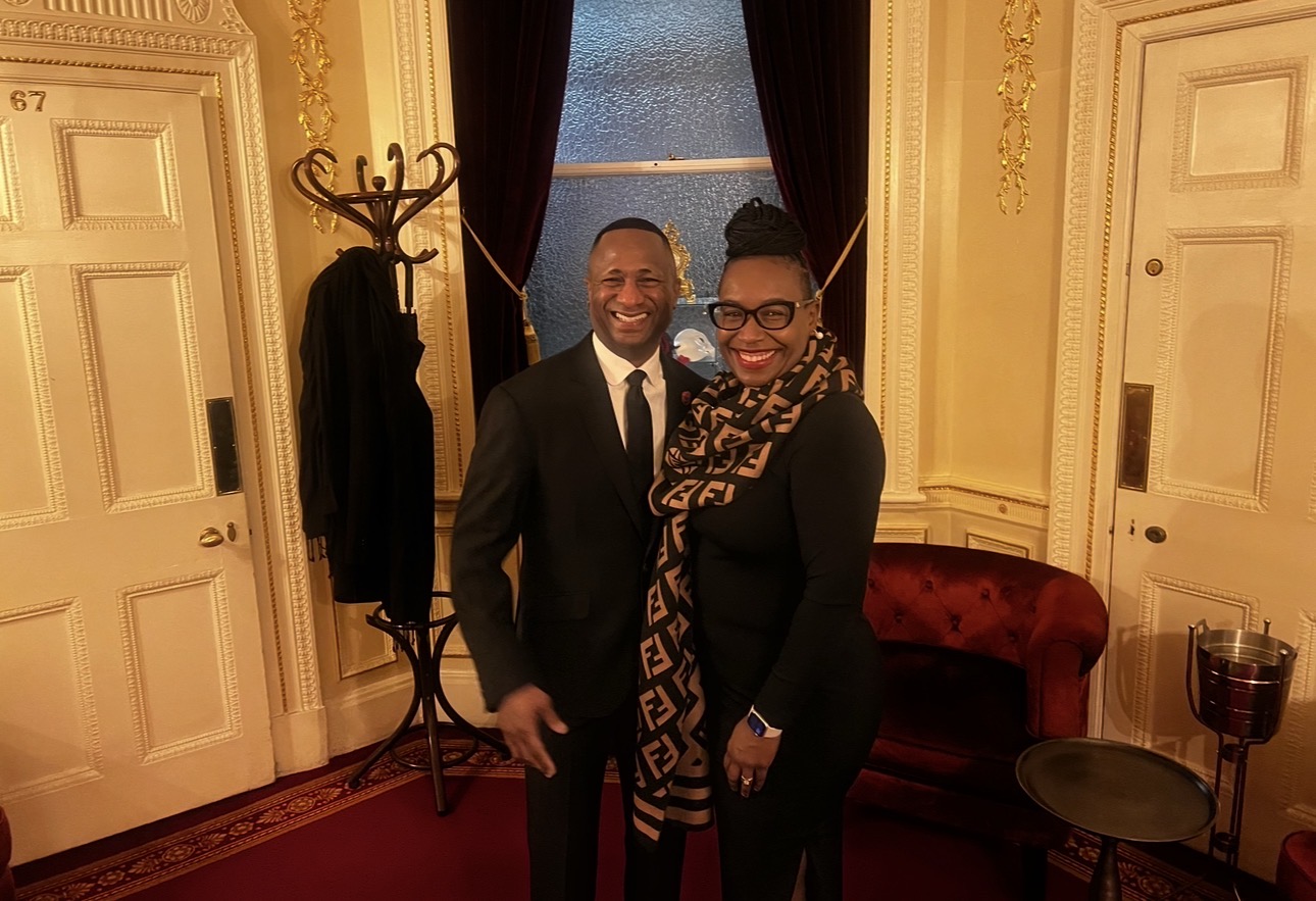 Two people posing together at a formal reception